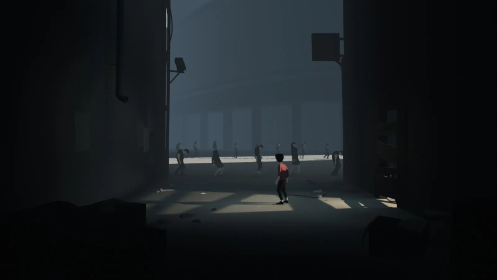 alt: A screenshot from Inside showcasing the minimalist art style with the boy in a dimly lit area.