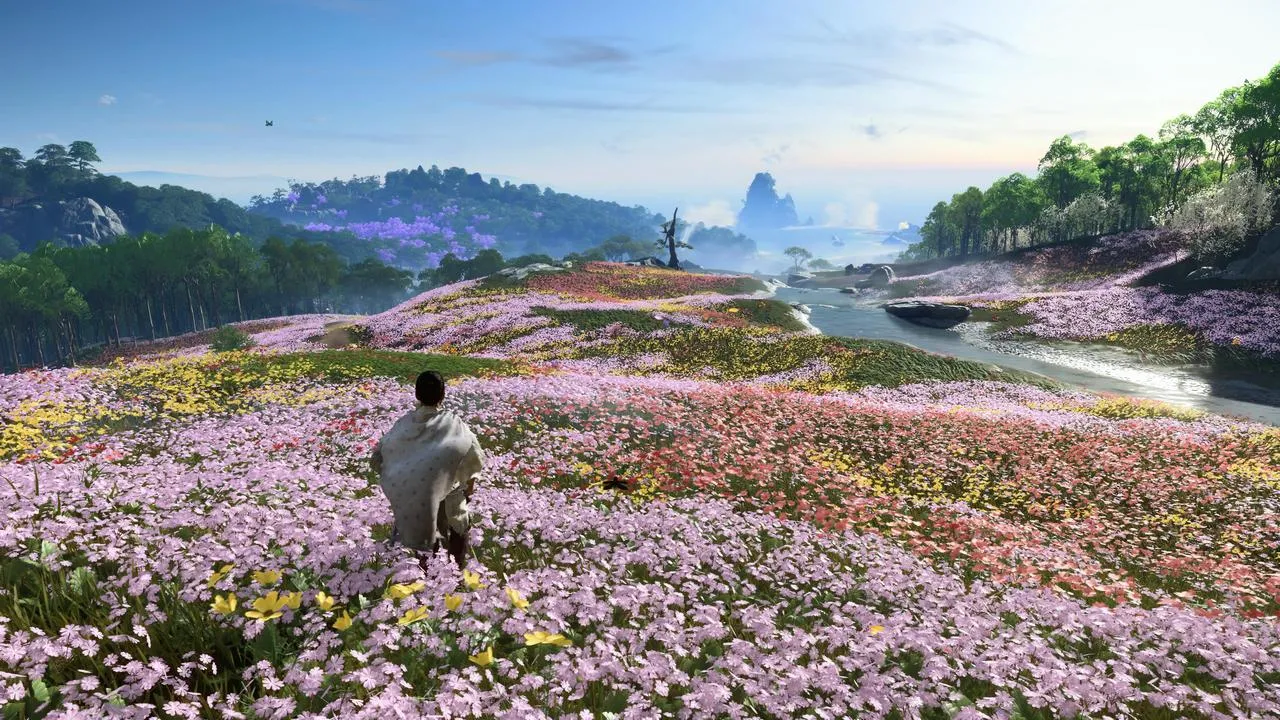 Alt: Jin Sakai standing on a cliff overlooking the ocean on Iki Island.  The image showcases the game's visual fidelity.