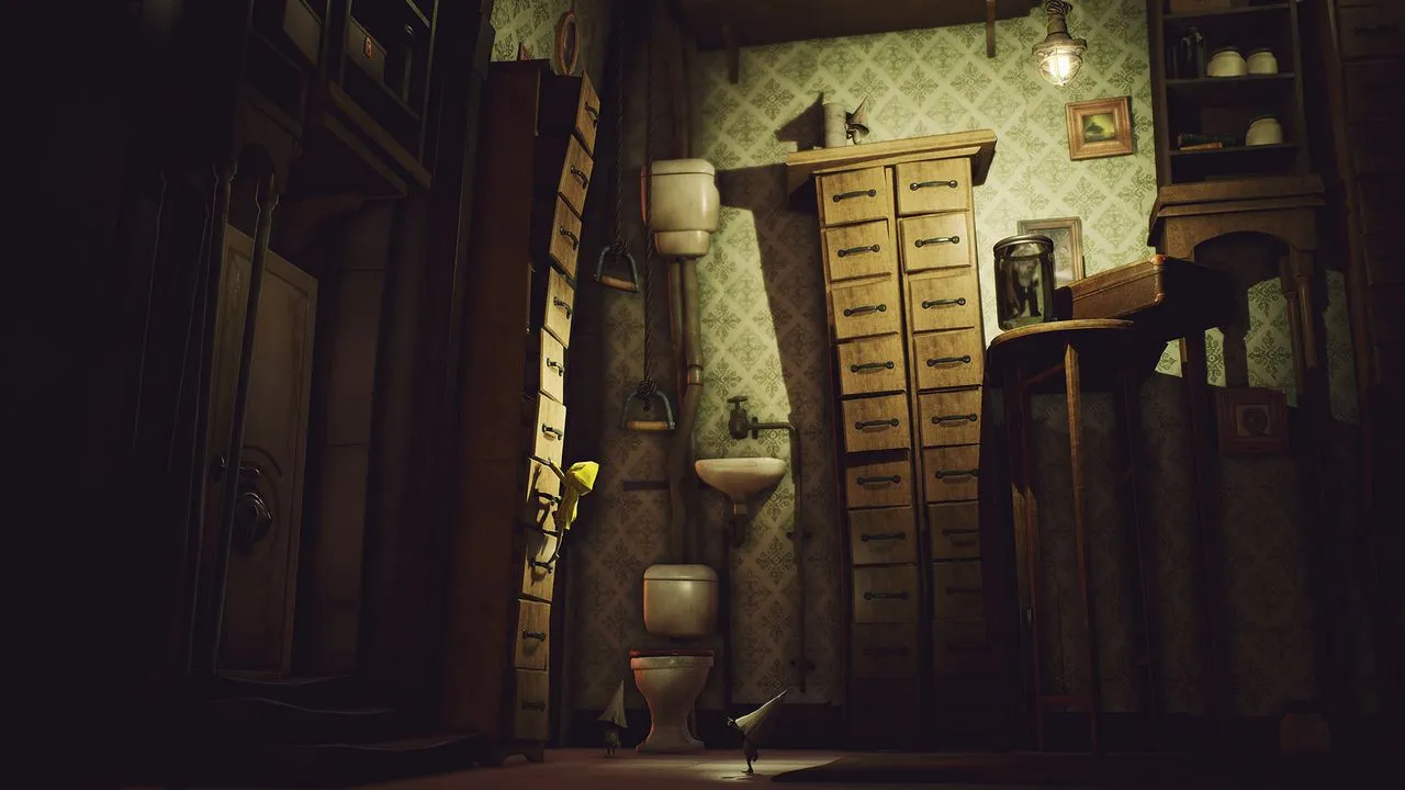 alt: Six in a dark room with a single light source in Little Nightmares