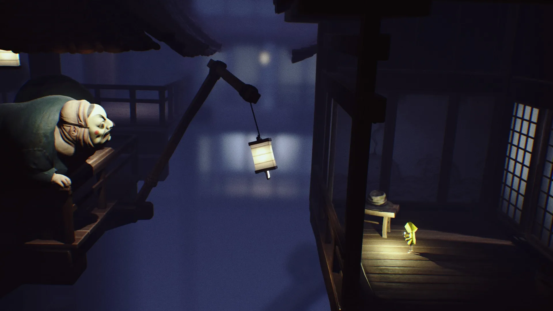 alt: Six standing in front of a locked gate in Little Nightmares