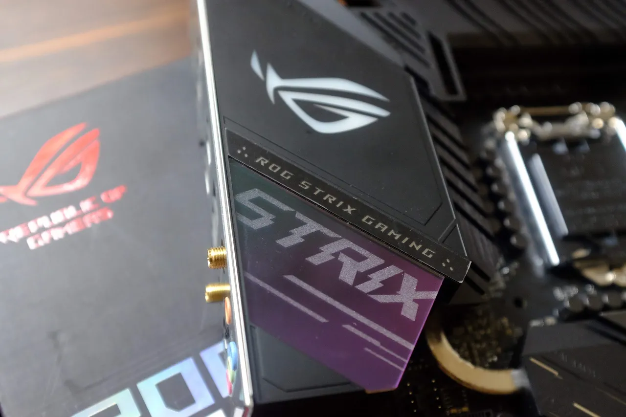 alt text: A closer look at the ASUS ROG Strix Z490-E Gaming's chipset heatsink, featuring the illuminated ROG logo and sleek design.