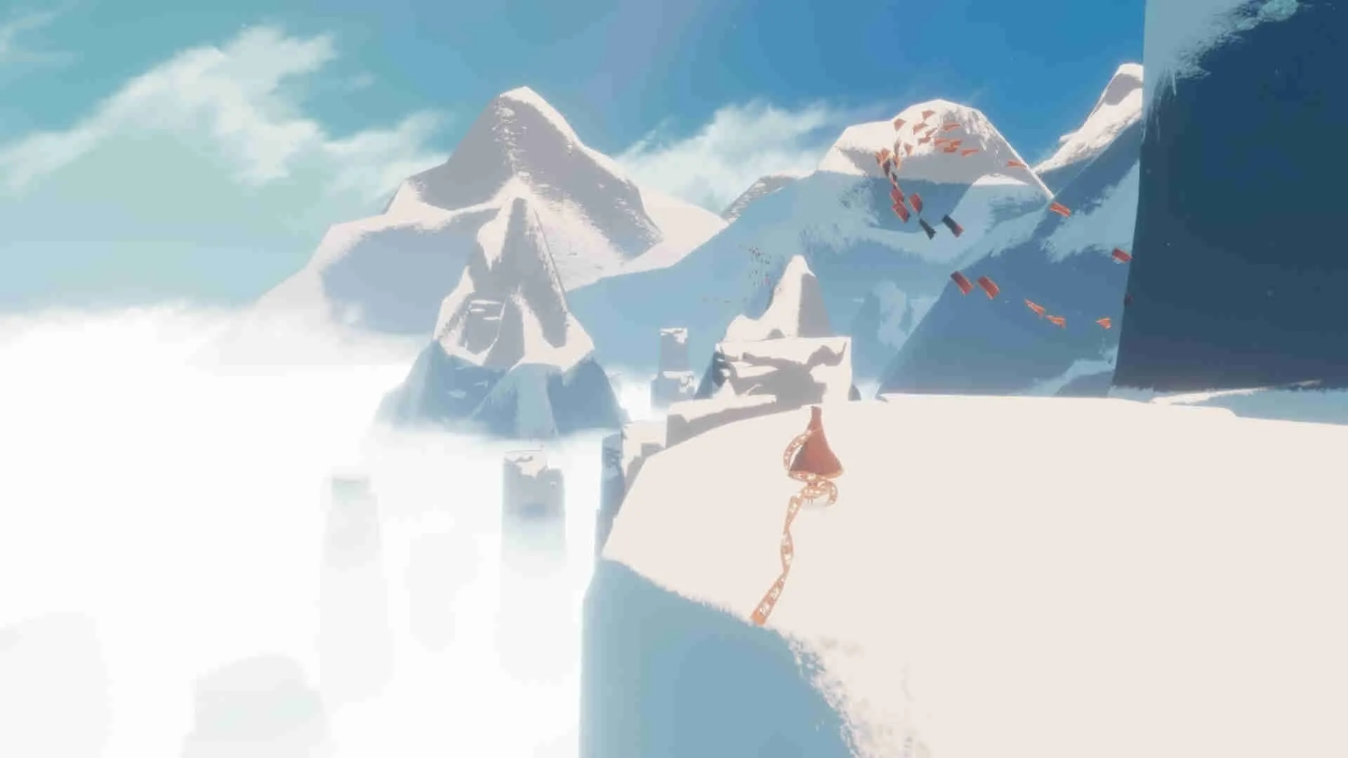 alt text: A robed figure standing before a large, ornate structure in Journey.
