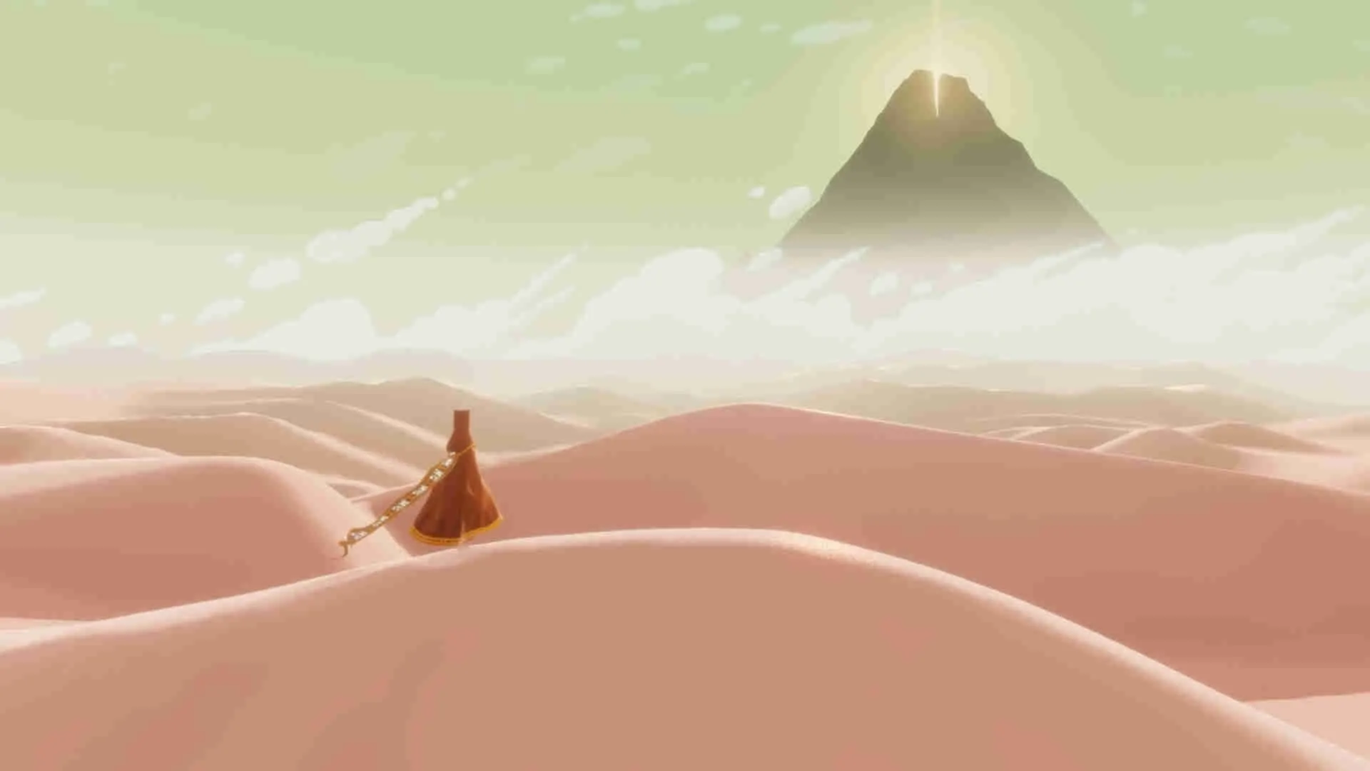 alt text: A robed figure standing in a vast desert, gazing towards a distant mountain.