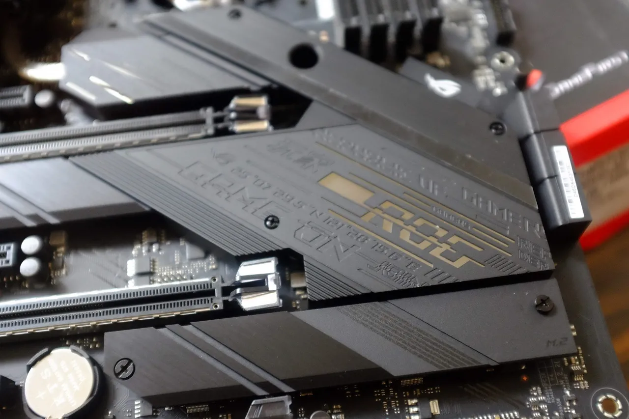 alt text: Close-up of the ASUS ROG Strix Z490-E Gaming's VRM heatsink, highlighting its robust construction and heat pipe integration.