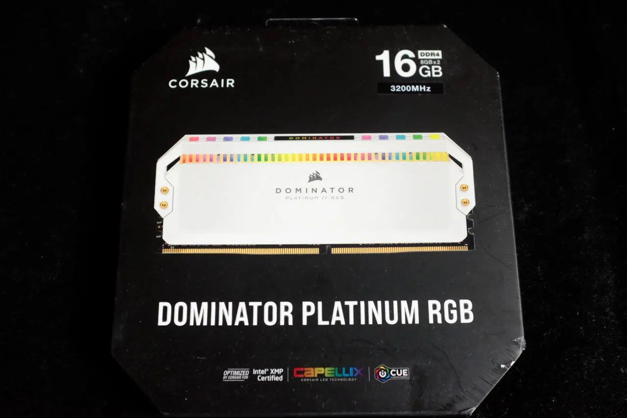 alt text: Close-up of the Corsair Dominator Platinum RGB White Edition RAM modules, highlighting the white finish and gold accents.