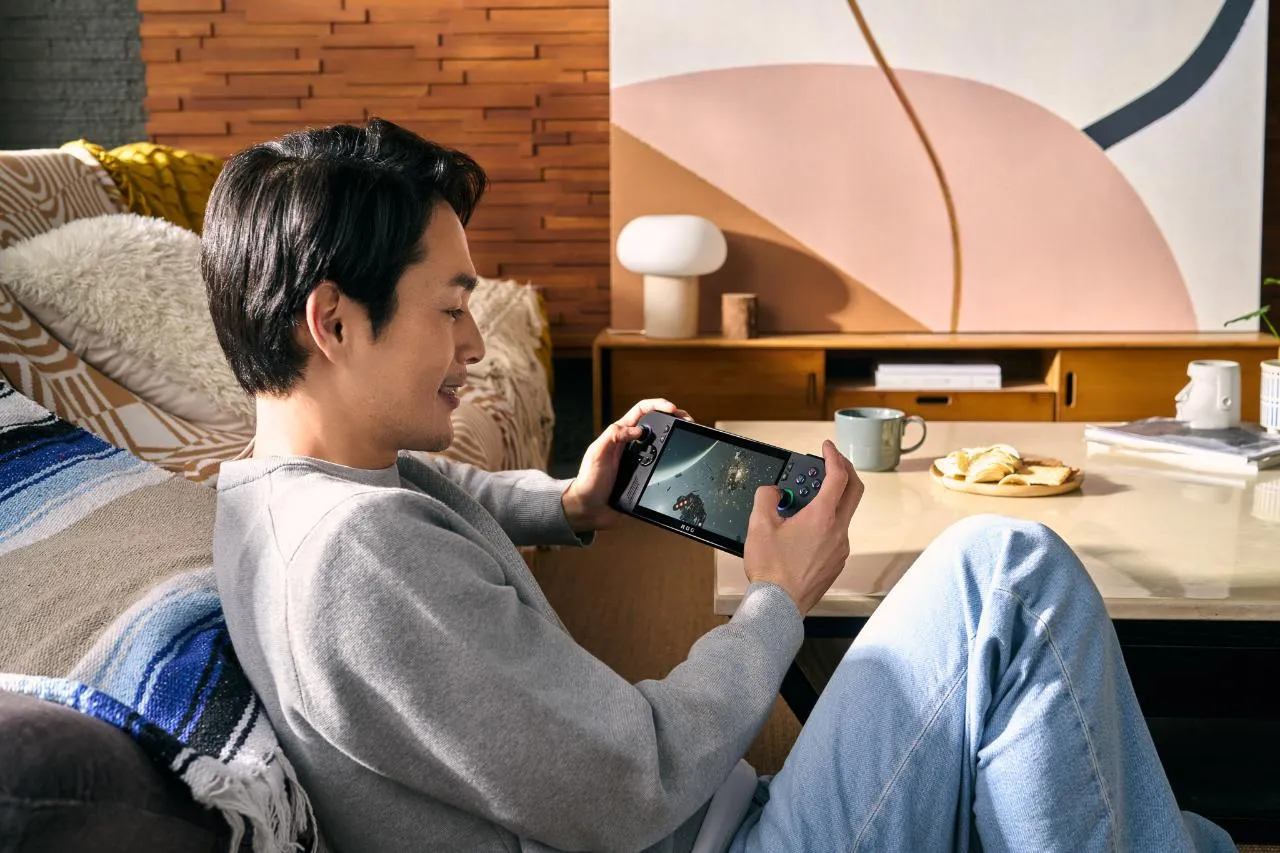 alt text: Close-up view of the new ASUS ROG Ally X handheld gaming console showcasing its sleek black design and improved controls