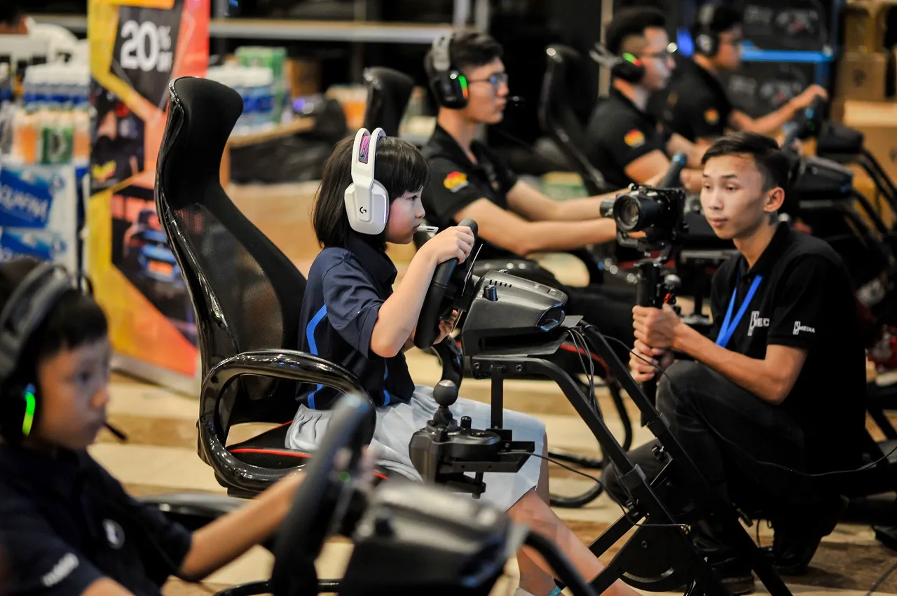 Participants experiencing the Logitech G29 racing wheel